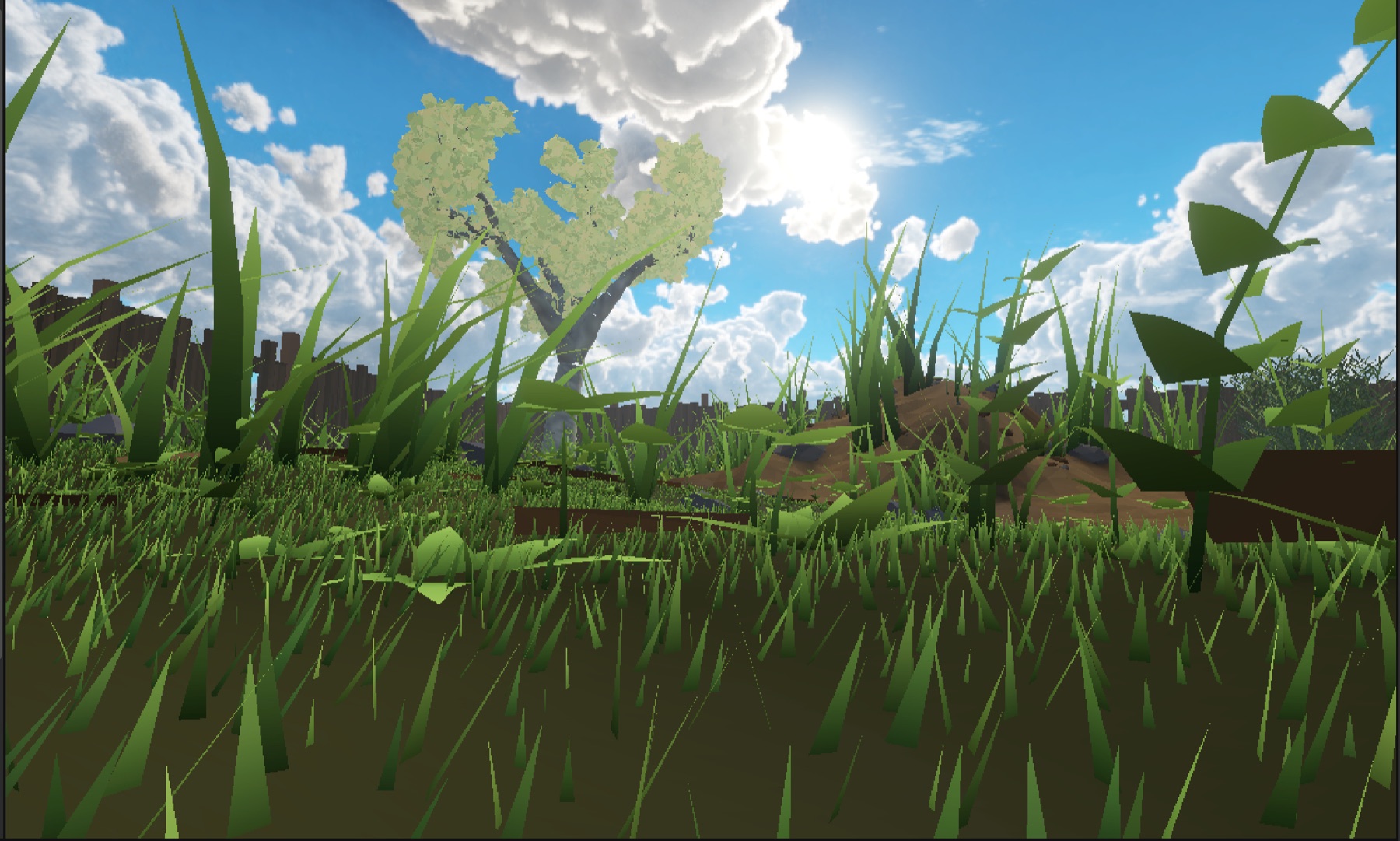 A screenshot from the game, taken at insect height: blades of grass tower over the camera, a fence and a pale-leaved tree stand against a bright blue sky with heavy cumulus cloud, and a mound of bare earth rises behind the grass to the right.